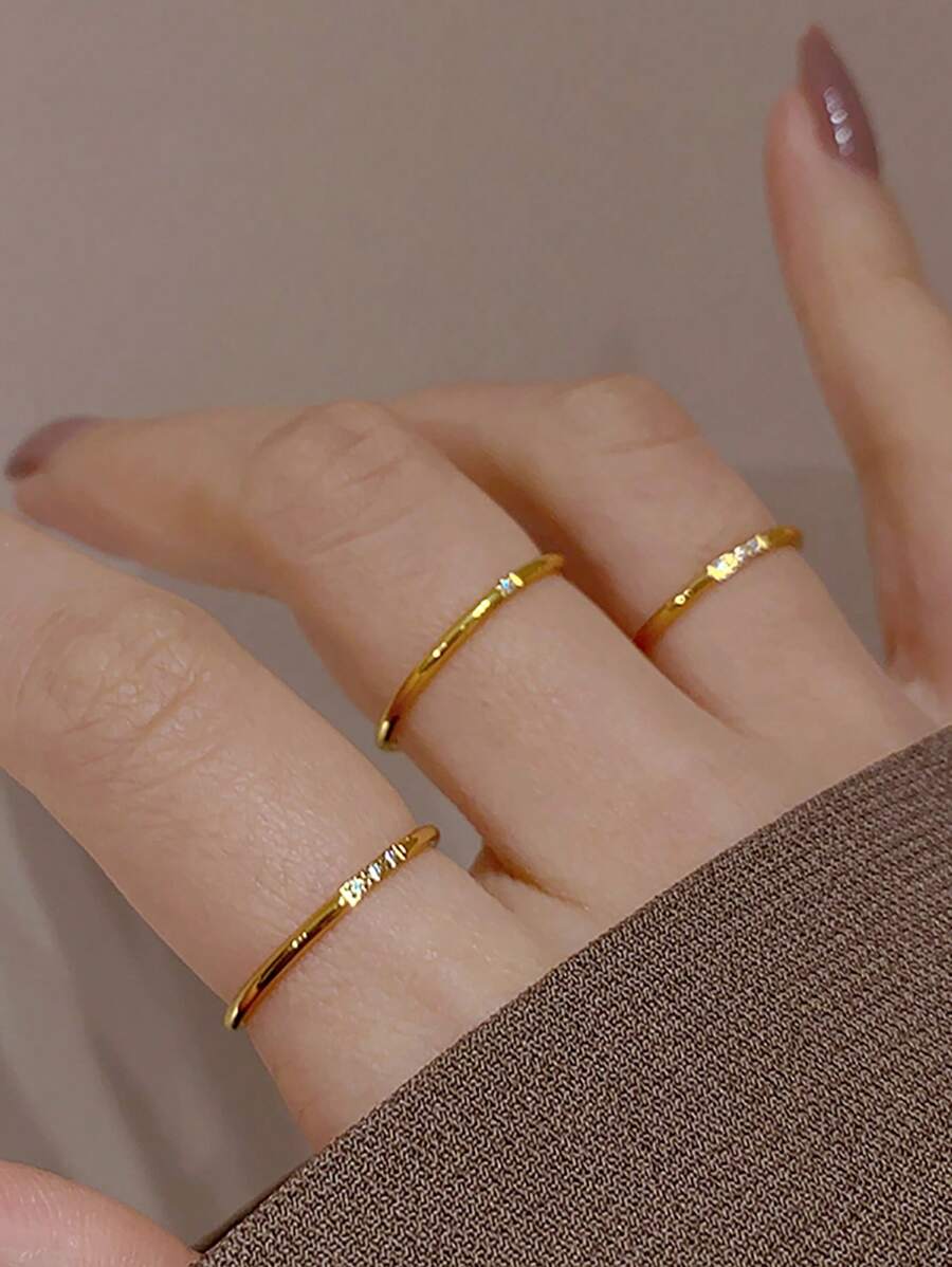 Gold-tone Subtle Spark rings with cubic zirconia detail