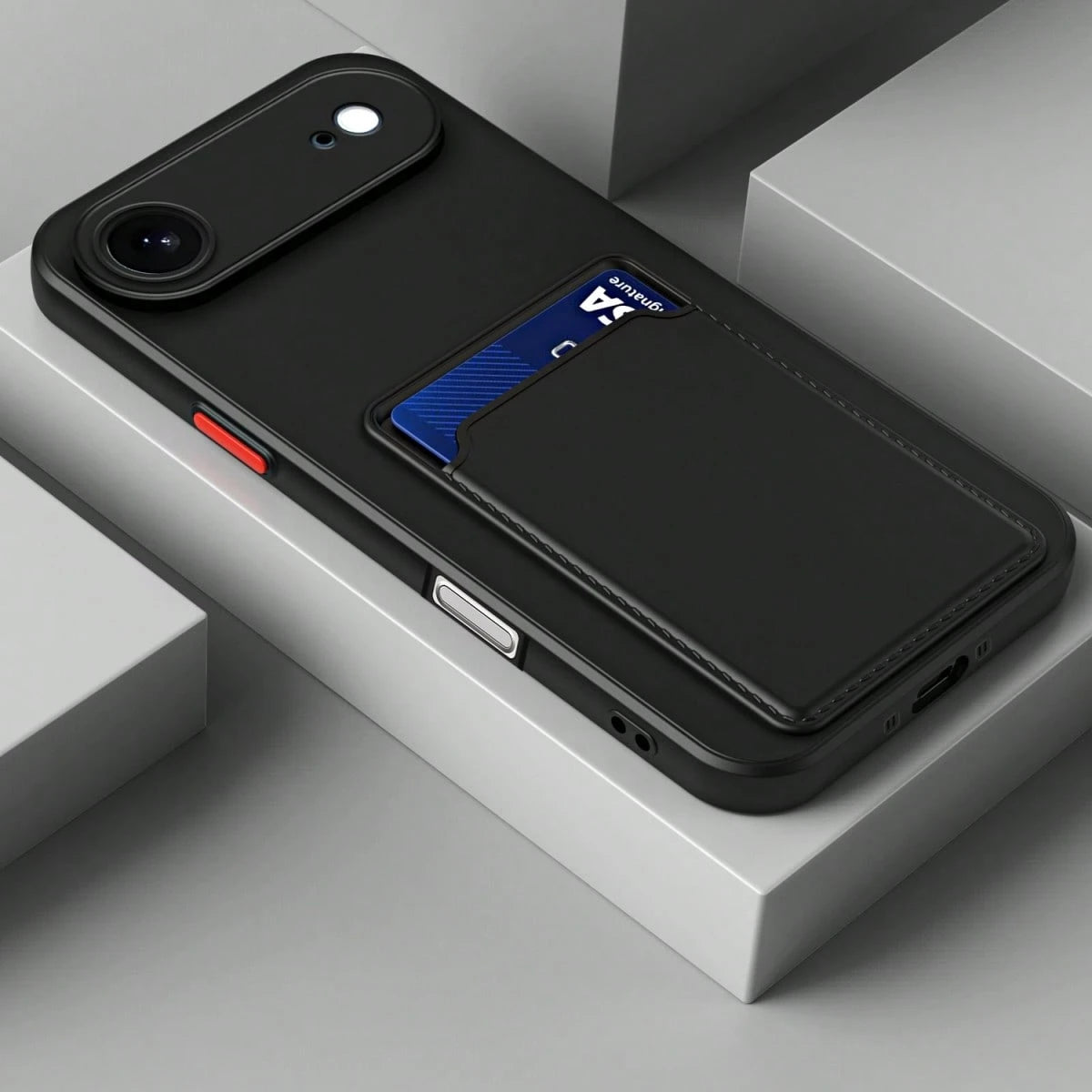 Black phone case on a grey display block showing the integrated rear card slot with an example card