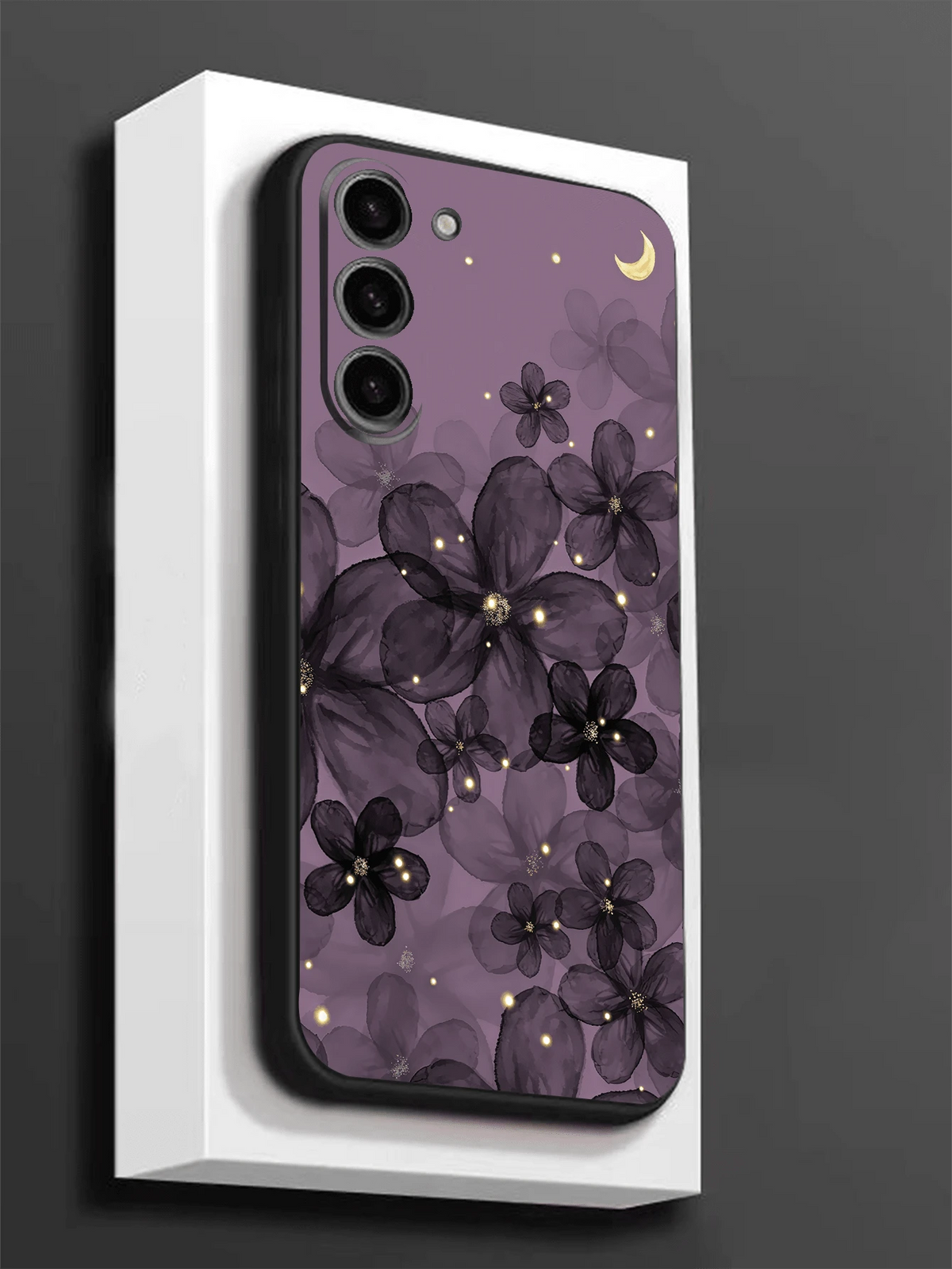 Purple floral moon phone case standing on a white display block