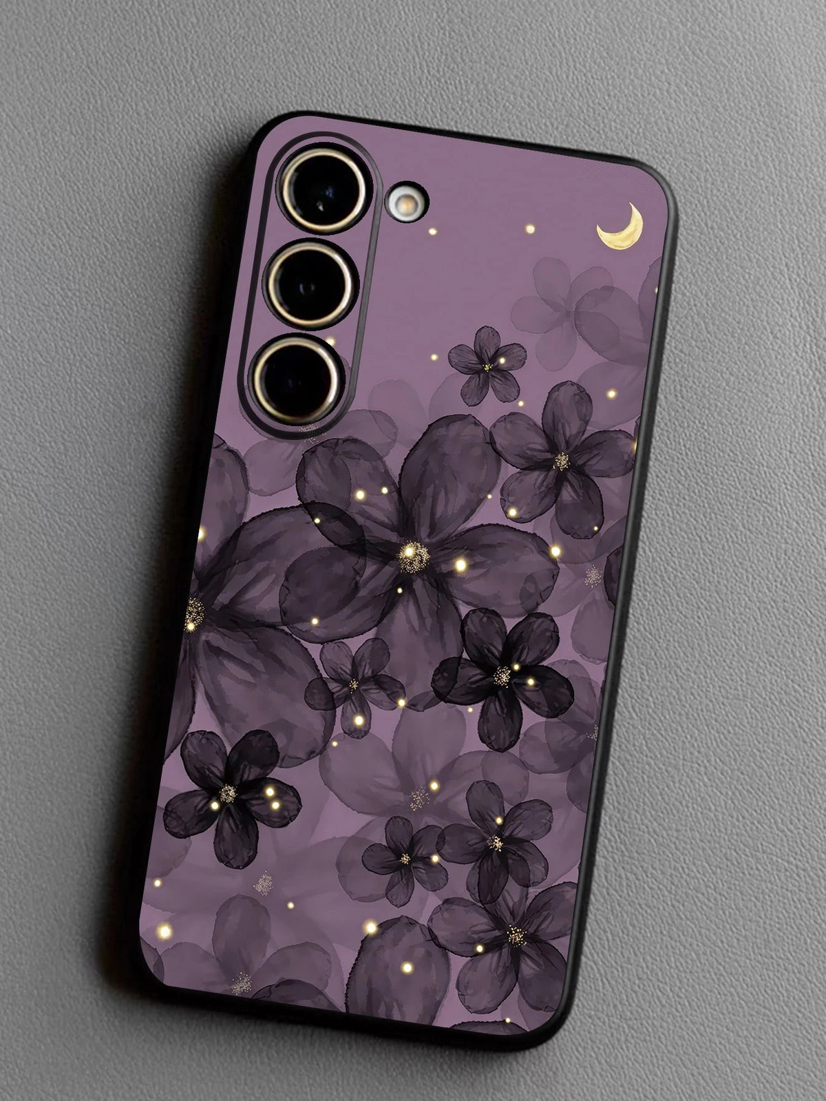 Close-up of purple floral moon case with black edges and camera openings